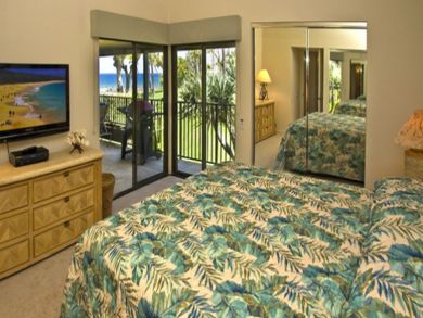 Bedroom with king bed, flat screen & open to balcony